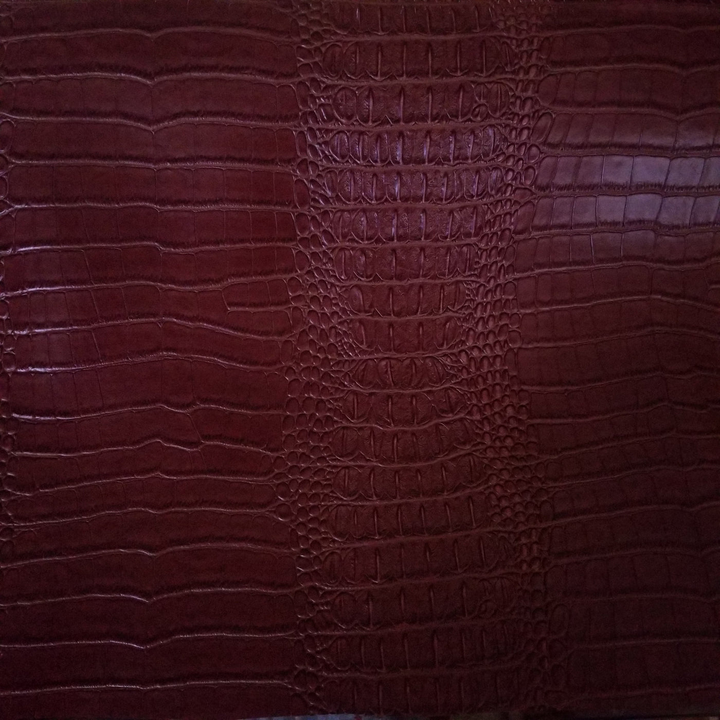 texture of red maroon genuine leather, like crocodile skin Stock Photo